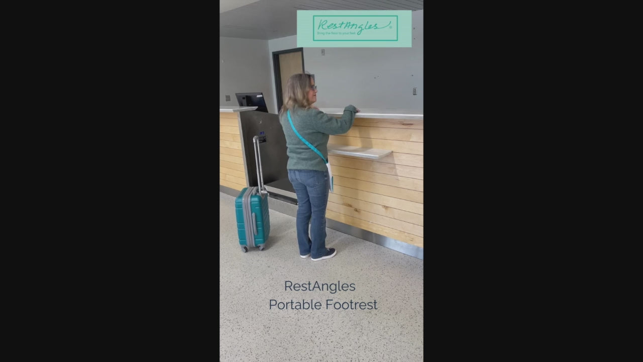 Load video: A woman, 4 feet 11 inches tall, stands at an airline counter in Kenai, Alaska, with her carry-on luggage, preparing to check in for her flight. She reaches into her turquoise and white crossbody tote bag, retrieving her Alpine Gray RestAngles portable travel footrest. The scene transitions as the camera follows her through the airport terminal, highlighting her effortlessly assembling, disassembling, and using RestAngles in the waiting areas. Behind her, large windows reveal the airport tarmac suggesting one use for RestAngles is as a travel accessory. Lively, four-count instrumental music sets the tone for the video, which features no spoken dialogue, focusing entirely on her journey and the convenience of RestAngles.